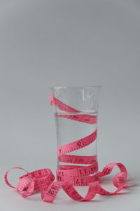 Close-up of pink glass against white background