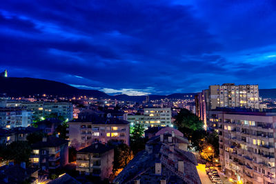 High angle view of illuminated buildings against sky at night