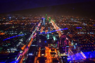 High angle view of illuminated buildings in city at night