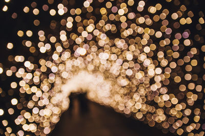 Defocused image of illuminated christmas lights at night