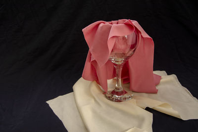 High angle view of rose in glass on table