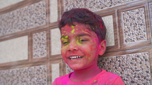 Attractive boy in pink colors holi. holi facial shot on spring color festival of holi. holi celebr