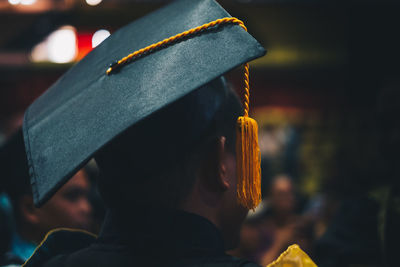 Rear view of man holding hat