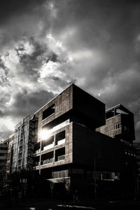 Low angle view of building against cloudy sky