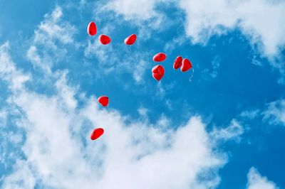 Low angle view of balloons against sky