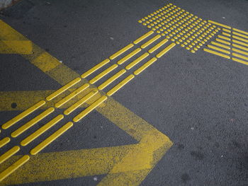 High angle view of yellow road marking on street