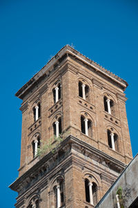 Low angle view of building against clear blue sky