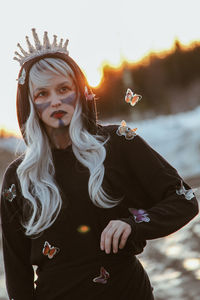 Young woman wearing hat standing outdoors