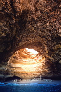 Scenic view of sea seen through cave