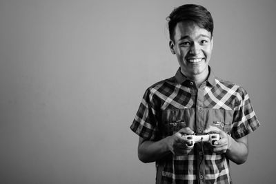 Portrait of smiling young man against white background