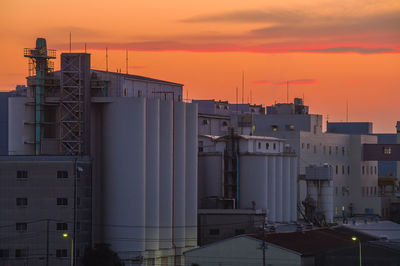 Modern buildings against sky during sunset