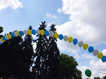 Low angle view of balloons against sky