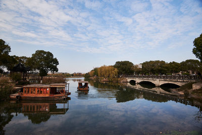 Arch bridge over river against sky