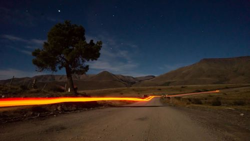 Scenic view of land against sky at night