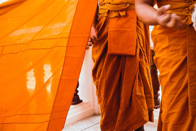 Low section of people standing on cross