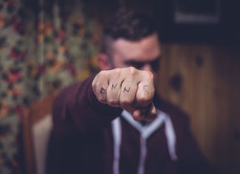 Close-up of man's tattooed fingers