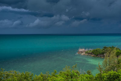 Scenic view of sea against storm clouds
