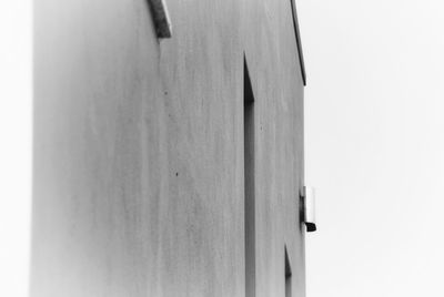 Close-up of wooden door against white wall