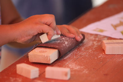 Close-up of man preparing food on cutting board