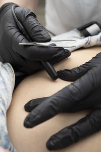 Low section of woman sitting on bed