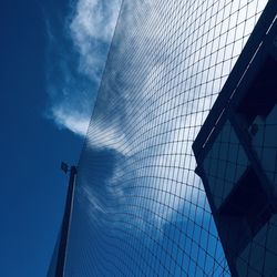 Blue sky with high football mesh fence