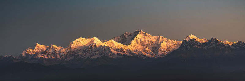 Scenic view of snowcapped mountains against sky during winter