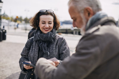 Smiling woman talking to man