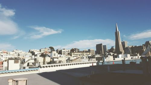 Buildings in city against blue sky