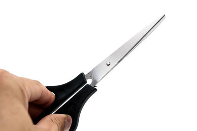 Close-up of hand holding crane against white background