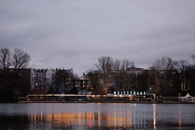 Scenic view of lake by buildings against sky