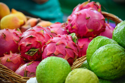 Close-up of pitayas and guavas in basket