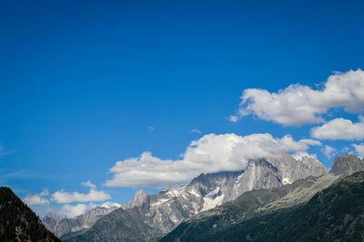 Scenic view of mountains against blue sky