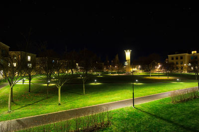 Illuminated city against sky at night