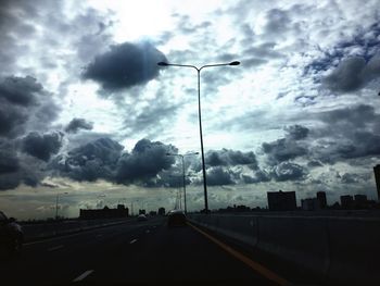 Low angle view of street light against cloudy sky