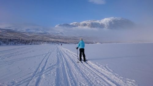 Tourists on snow covered mountain