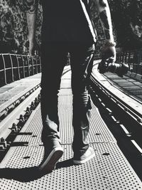 Low section of people standing on railroad station platform
