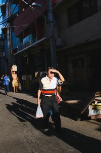 Full length of man standing in city