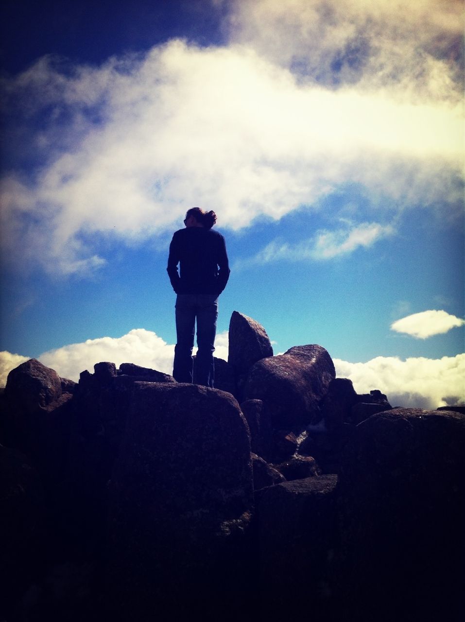 sky, cloud - sky, low angle view, rock - object, silhouette, mountain, cloud, tranquility, nature, standing, lifestyles, leisure activity, tranquil scene, men, scenics, cloudy, beauty in nature, day