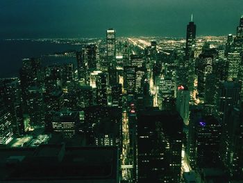 Aerial view of city lit up at night
