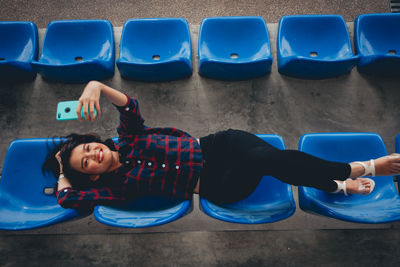 High angle view of boys sitting on sofa