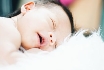 Close-up of baby boy sleeping on rug