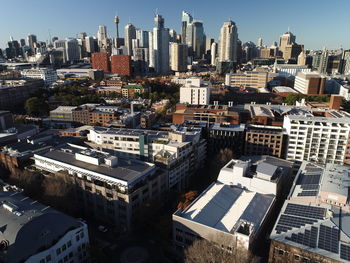 High angle view of modern buildings in city against sky