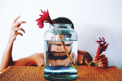 Close-up of hand feeding in jar