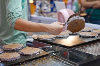 Midsection of man preparing food