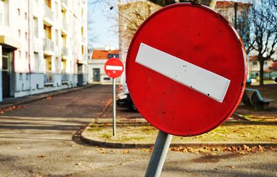 Close-up of road sign against sky