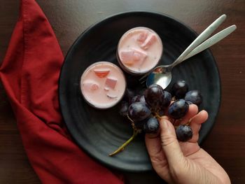 High angle view of man holding fruits in bowl