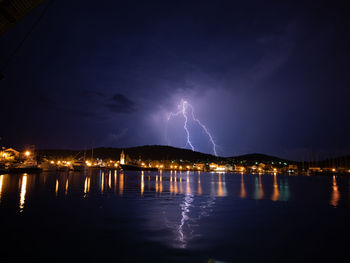 Lightning over illuminated city at night