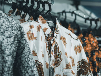 Close-up of clothes hanging for sale at market stall