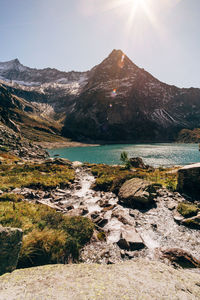 Scenic view of lake and mountains against sky