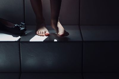 Low section of woman walking on steps